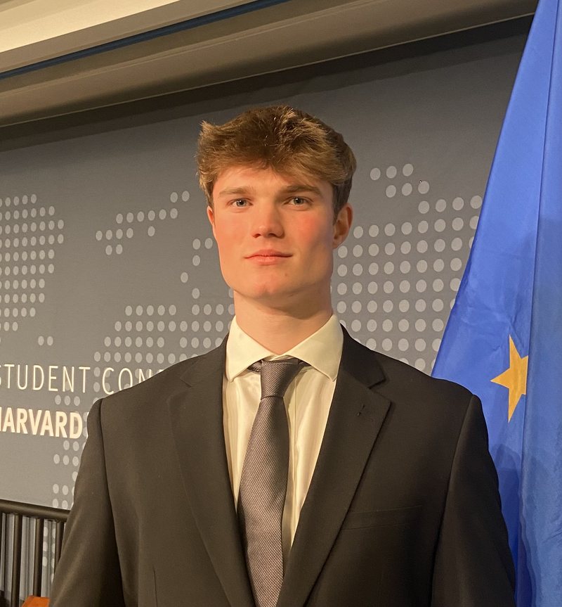 Alfred Williamson at the Harvard Student Conference, in front of an EU flag